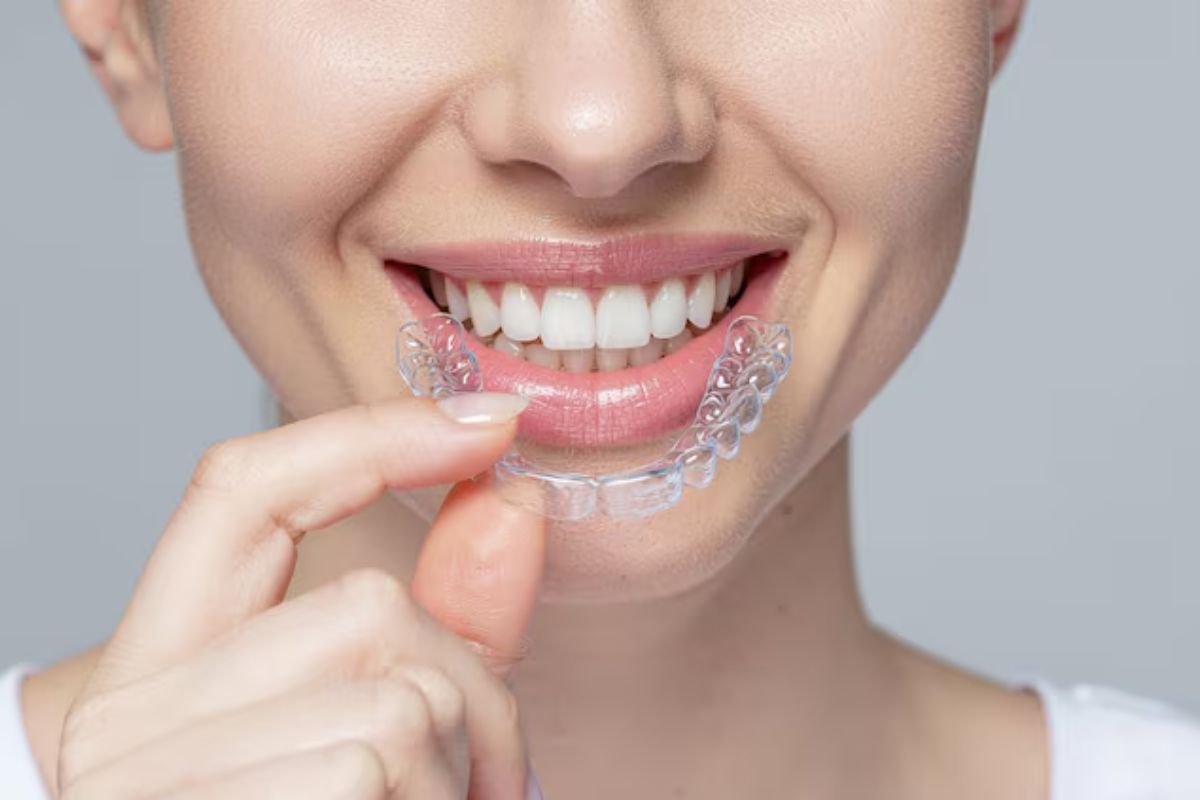 patient holding clear invisalign aligners for discreet teeth straightening treatment