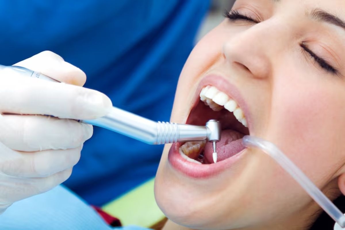 dentist performing a dental procedure to clean and protect a patient’s teeth.